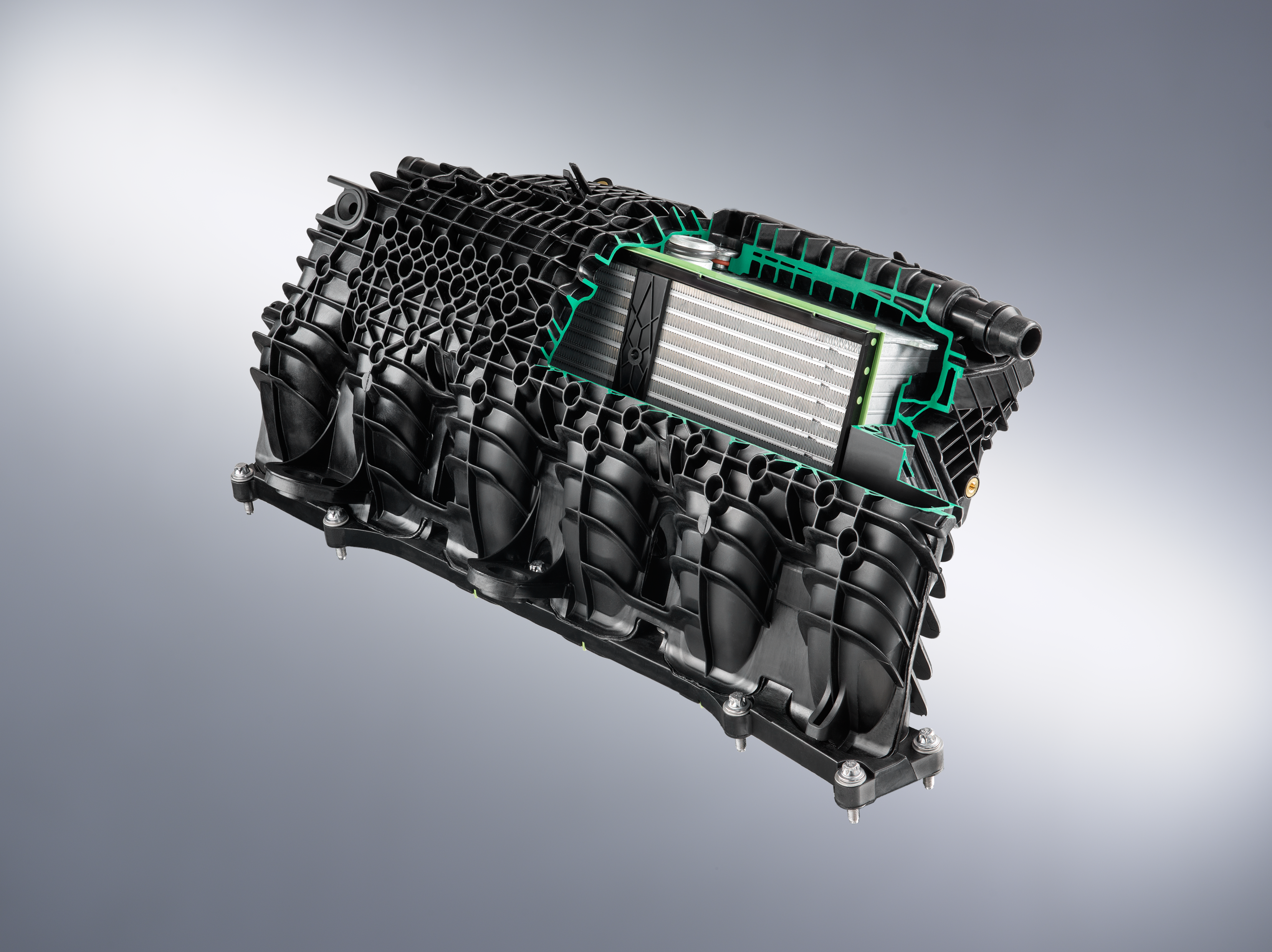 Heel veel ribben buitenop helpen het kunststof spruitstuk aan genoeg sterkte, ribben binnenin geleiden de druklucht optimaal naar de zes inlaatbuizen.