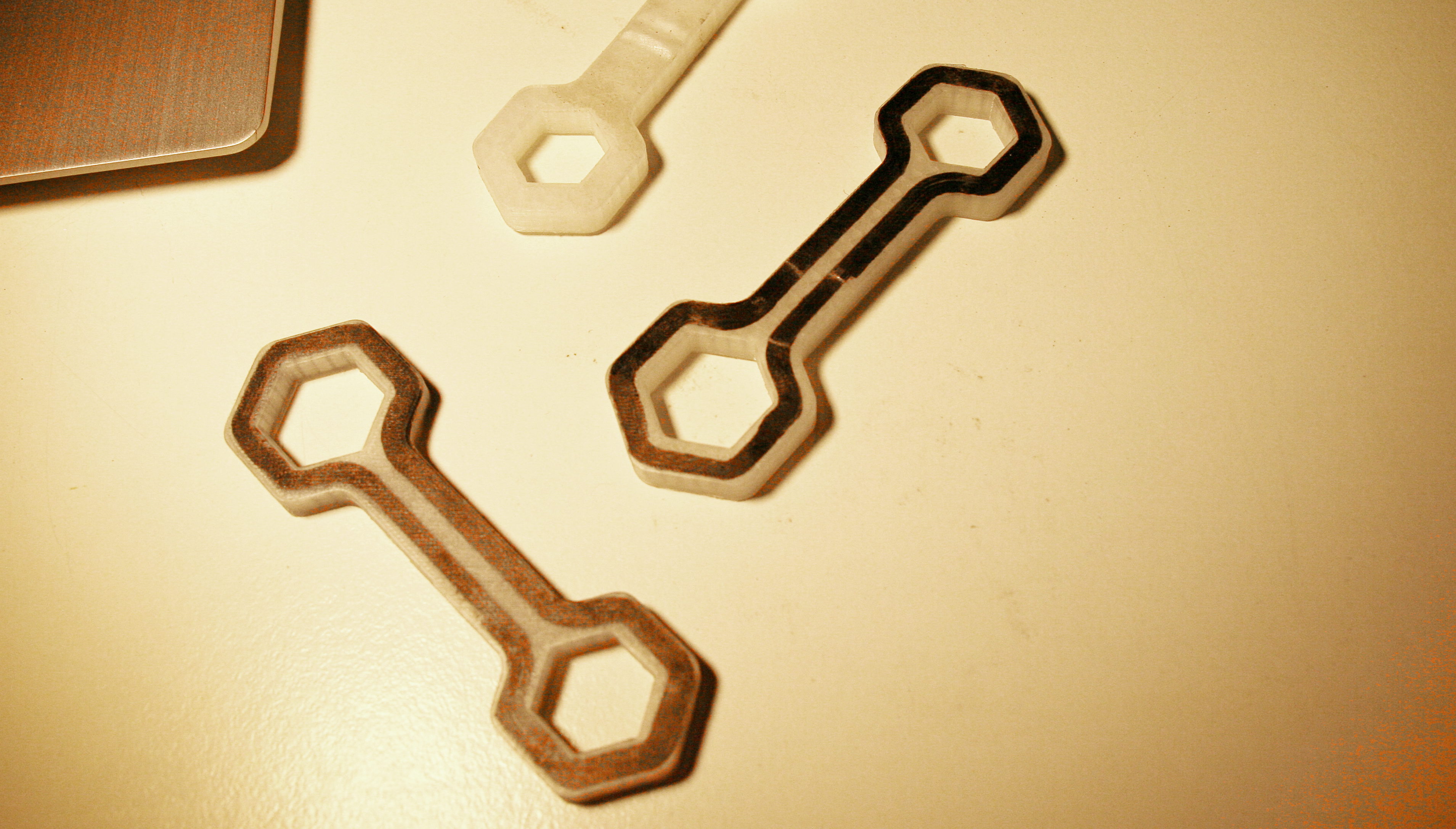 Met een 3D-printer kun je nylon printen. Als je daar in één print een paar laagjes koolstof- en/of glasvezels aan toevoegt, is het ideaal om er specialistisch gereedschap van te maken: goedkoop en zo sterk als een trekhaak. 