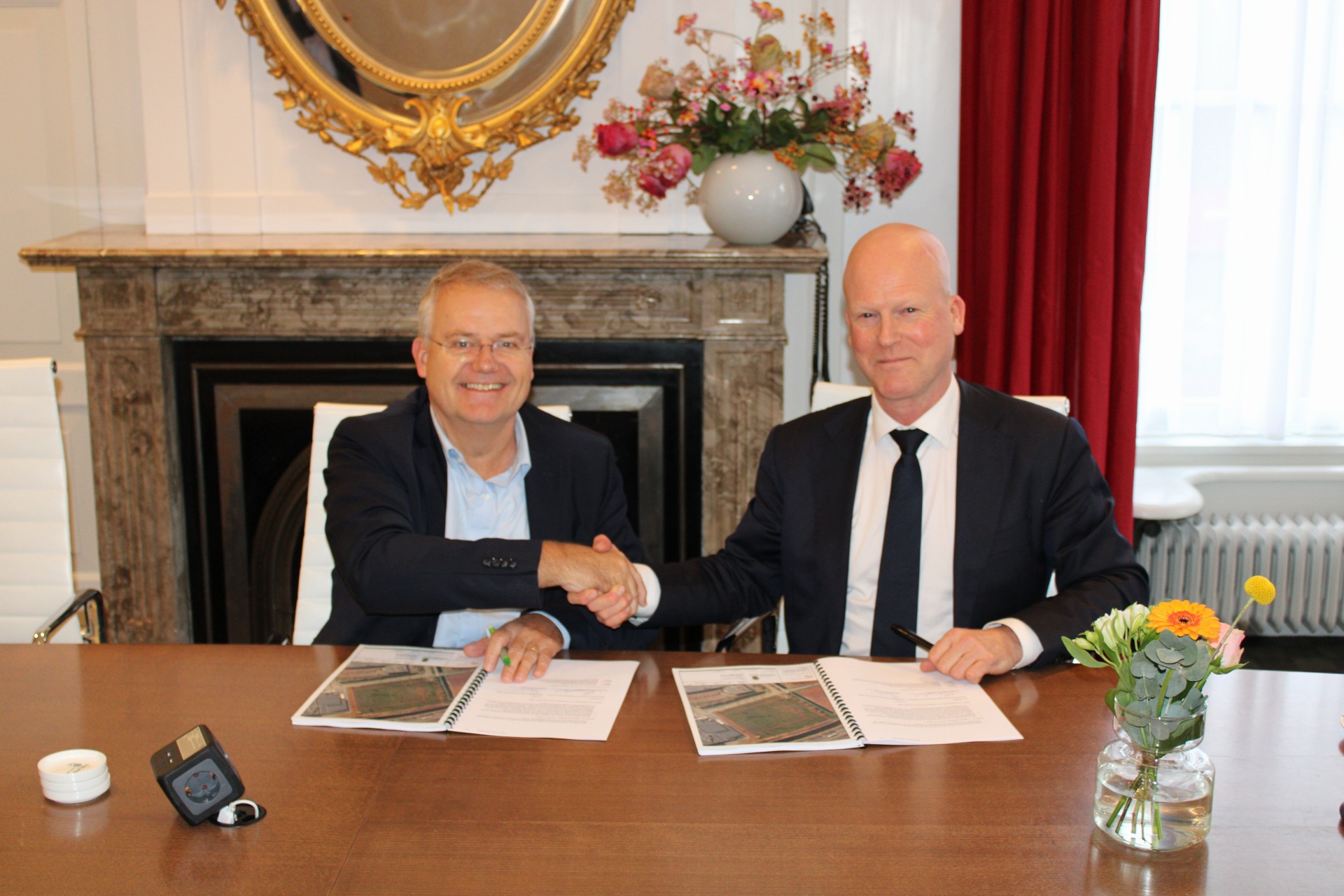 Zeger Baelde (directeur bedrijfsvoering van de RDW, links) en wethouder Marcel van Opzeeland van de Gemeente Opsterland bij het ondertekenen van de koopakte. - Foto: RDW